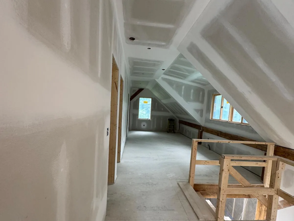 Drywall hung and taped through a long dormered attic space